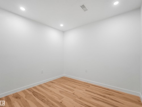 Room featuring light wood-finish flooring, white walls, recessed ceiling lighting, and a ceiling air vent - 17171 38 Street, Edmonton, AB 
