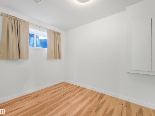 Room featuring light wood-finish flooring, white baseboards, and a white ceiling - 17171 38 Street, Edmonton, AB 