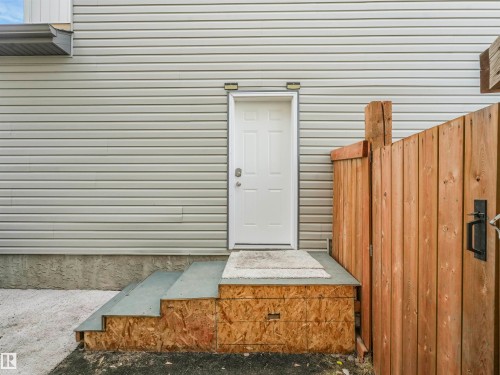White exterior door with grey vinyl siding - 17171 38 Street, Edmonton, AB 