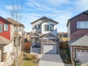 Two-story residence featuring a stone and siding exterior, an attached single-car garage, and a concrete driveway - 17171 38 Street, Edmonton, AB 