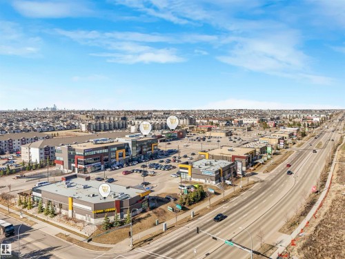 Commercial development featuring multiple buildings with varied architectural facades, extensive surface parking, and direct frontage on a multi-lane thoroughfare - 17171 38 Street, Edmonton, AB 