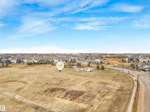 Expansive open field with scattered dry grass and visible dirt patches - 17171 38 Street, Edmonton, AB 
