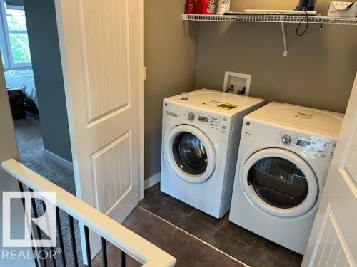 Dedicated laundry area featuring a front-loading washer and dryer set - 138 Reed Place, Leduc, AB 
