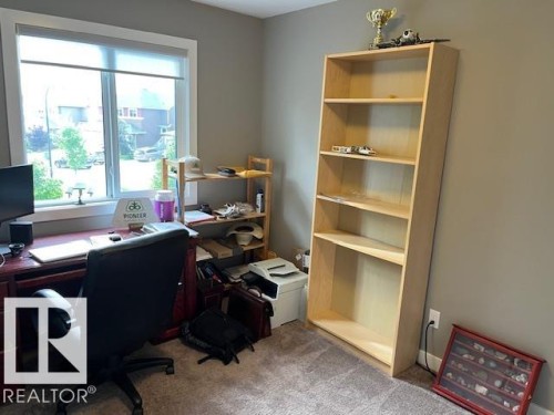 Light gray painted walls complementing textured carpet flooring - 138 Reed Place, Leduc, AB 