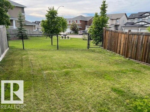 Expansive fenced yard featuring a mix of wood panel and chain link fencing - 138 Reed Place, Leduc, AB 