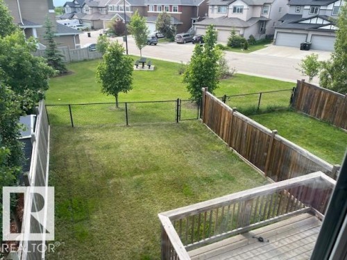 Private backyard featuring a wood deck and durable wood fencing - 138 Reed Place, Leduc, AB 