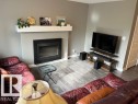 Contemporary fireplace with a white mantel and light gray walls - 138 Reed Place, Leduc, AB 