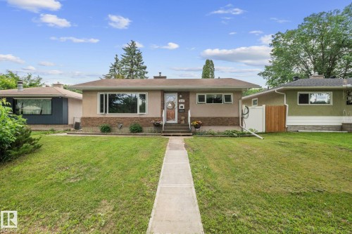 Single-story residence featuring a neutral stucco and brick facade - 12115 53 Street, Edmonton, AB 
