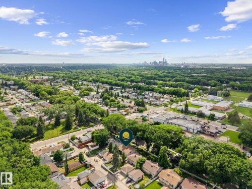 Aerial perspective showcasing a residential neighborhood with a distant cityscape - 12115 53 Street, Edmonton, AB 