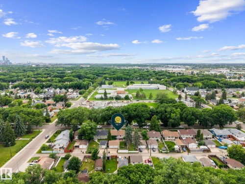 Aerial perspective showcasing a residential neighborhood with tree-lined streets and established homes - 12115 53 Street, Edmonton, AB 