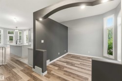 Archway entry with recessed lighting, wood-finish flooring, and a contrasting accent wall - 