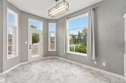 Bright interior space featuring a white French-style door and multiple windows providing abundant natural light - 