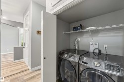 Dedicated laundry closet featuring wire shelving and light gray walls - 