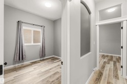 Neutral gray wall paint throughout, complemented by wood-finish flooring - 