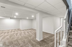 Finished lower level featuring recessed lighting, a drop ceiling, and plush patterned carpet - 
