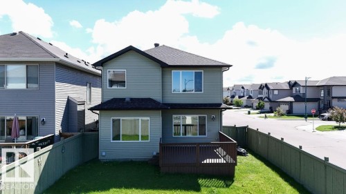 Two-story residence with light green siding and dark trim - 1306 32A Street, Edmonton, AB 