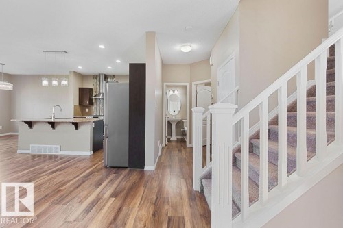 Open-concept living space featuring wood-finish flooring - 1306 32A Street, Edmonton, AB 