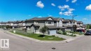 Row of contemporary two-story homes featuring attached garages, gabled roofs, and varied siding finishes - 1306 32A Street, Edmonton, AB 
