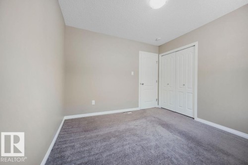 Neutral-toned walls complement the gray carpeted flooring - 1306 32A Street, Edmonton, AB 
