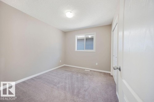 Neutral-toned walls complement plush grey carpeting - 1306 32A Street, Edmonton, AB 