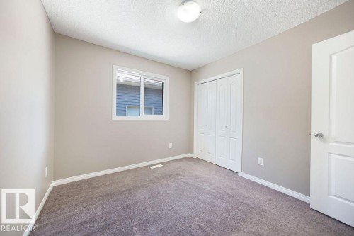 Neutral-toned walls complement plush grey carpeting - 1306 32A Street, Edmonton, AB 