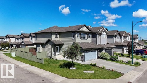 Contemporary two-story residence featuring light green siding and dark gray trim - 1306 32A Street, Edmonton, AB 