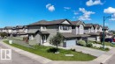 Contemporary two-story residence featuring light green siding and dark gray trim - 1306 32A Street, Edmonton, AB 