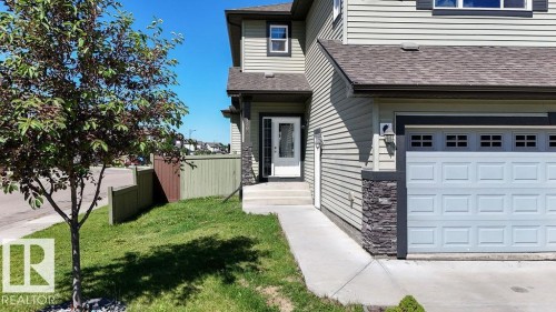 Two-story residence featuring light green horizontal siding and dark trim accents - 1306 32A Street, Edmonton, AB 