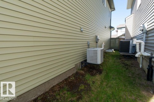 Horizontal siding facade with a visible outdoor HVAC unit - 1306 32A Street, Edmonton, AB 