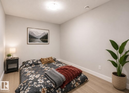 Light wood-finish flooring with white baseboards throughout - 1306 32A Street, Edmonton, AB 