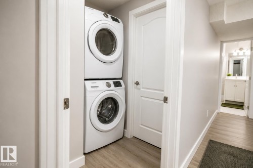Dedicated laundry area featuring a stacked washer and dryer - 1306 32A Street, Edmonton, AB 