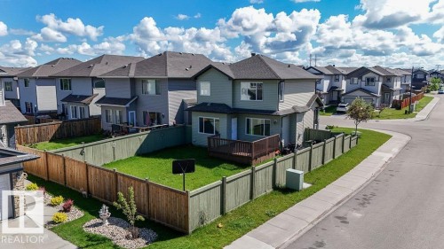 Two-story residence featuring a private backyard with a wooden deck - 1306 32A Street, Edmonton, AB 
