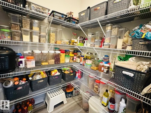Spacious pantry featuring extensive wire shelving, providing abundant storage capacity - 2534 Wonnacott Loop, Edmonton, AB 