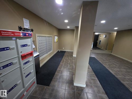 Mailroom featuring individual mailboxes and parcel lockers - #206 12045 22 Av Sw, Edmonton, AB - Indoor