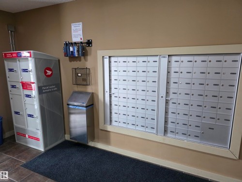 Community mailbox system with individual compartments and an integrated parcel locker - #206 12045 22 Av Sw, Edmonton, AB - Indoor