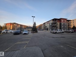Multi-story apartment building featuring balconies, a mix of panel siding, and stone facade - 