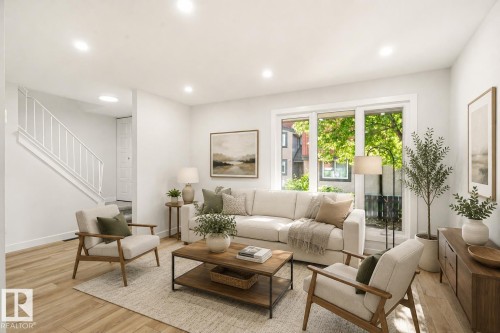 Bright living space featuring light wood-finish flooring, white walls, and recessed lighting - 18217 84 Avenue Nw, Edmonton, AB 
