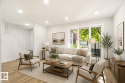 Bright living space featuring light wood-finish flooring, white walls, and recessed lighting - 