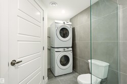 Compact laundry area with stacked washer and dryer units - 