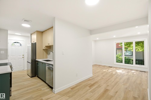Open-concept living space featuring wood-finish flooring throughout - 18217 84 Avenue Nw, Edmonton, AB 