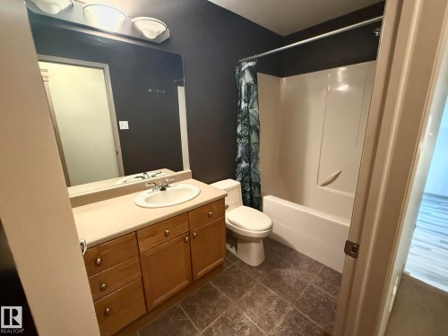 Bathroom featuring a light wood-finish vanity with ample storage, a white oval sink, and a large wall-mounted mirror - 1978 Tomlinson Green Green, Edmonton, AB 