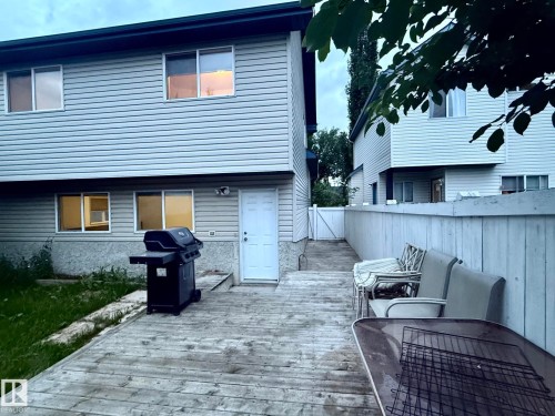 Rear exterior featuring horizontal vinyl siding and multiple windows - 1978 Tomlinson Green Green, Edmonton, AB 
