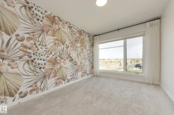 Accent wall featuring botanical-patterned wallpaper - 