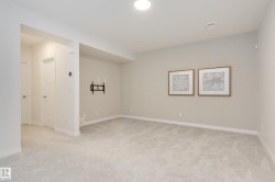 Carpeted interior space with a recessed ceiling light and neutral wall tones - 