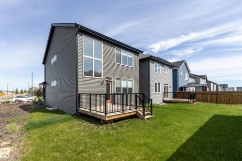 Contemporary two-story residence featuring gray horizontal siding and a black roof - 3249 Dixon Way, Edmonton, AB 