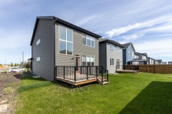 Contemporary two-story residence featuring gray horizontal siding and a black roof - 