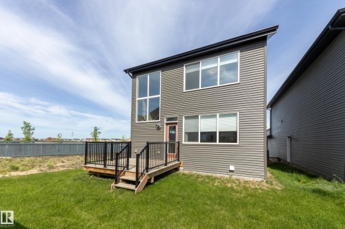 Modern two-story exterior featuring grey horizontal siding and a flat roofline - 3249 Dixon Way, Edmonton, AB 