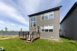 Modern two-story exterior featuring grey horizontal siding and a flat roofline - 