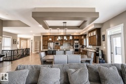 Open-concept living space featuring wood-finish flooring and recessed lighting - 