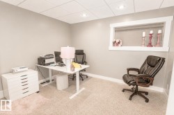 Carpeted room featuring a drop ceiling with recessed lighting - 